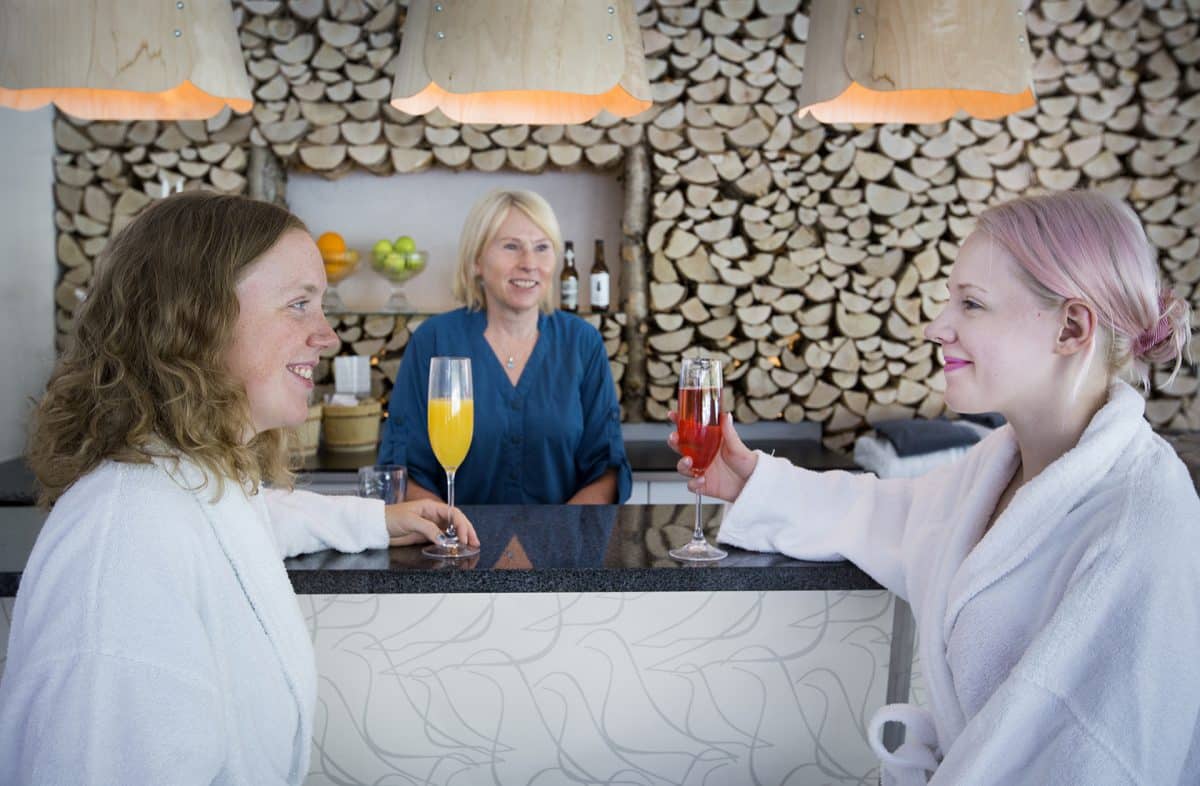 2 woman talking at the bar