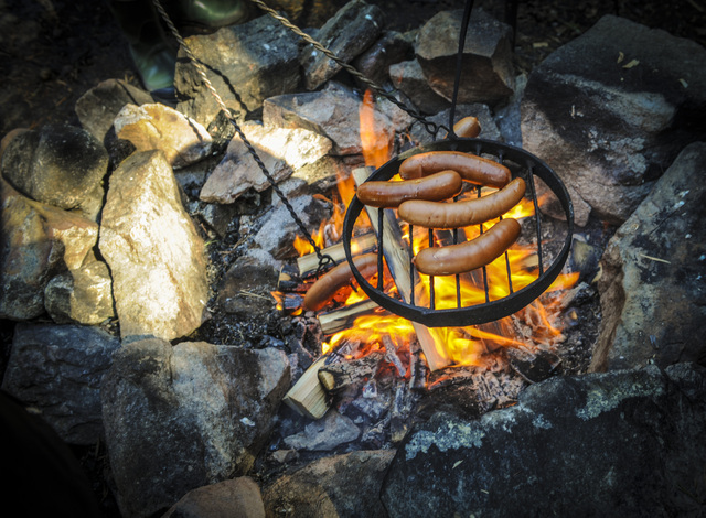sausages cooking on the fire