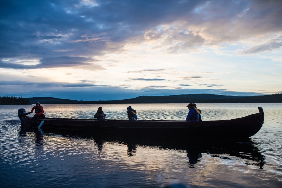 people on a long raft on the water in the summer