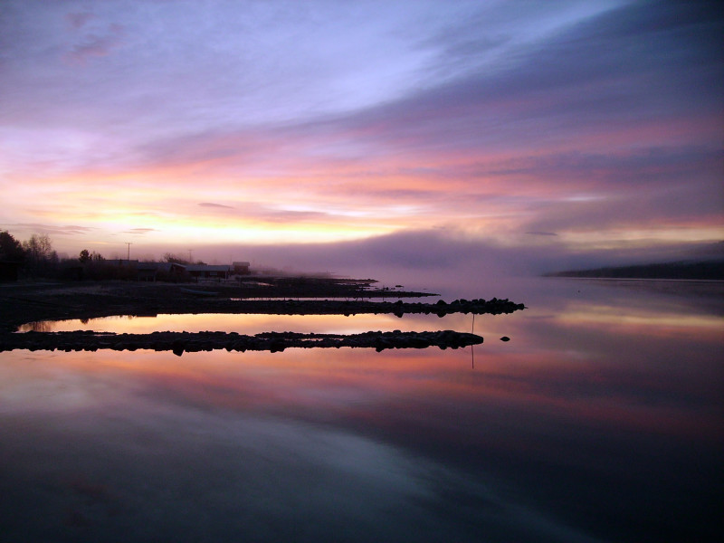 pink, orange and purple hues in the sky reflecting on the river