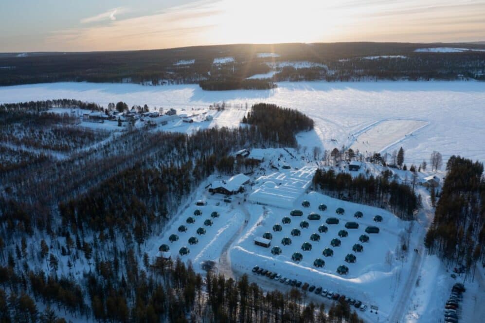 Aerial view of Arctic SnowHotel and glass igloos complex surrounded by snow