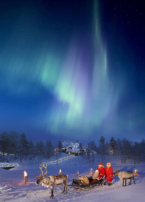 northern lights above reindeer sleigh
