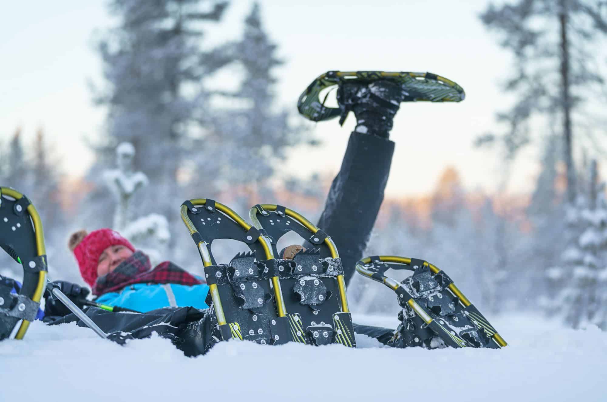 people led in the snow with snowshoes on
