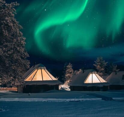 northern lights above aurora cabins