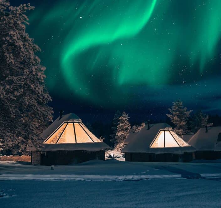 northern lights above aurora cabins