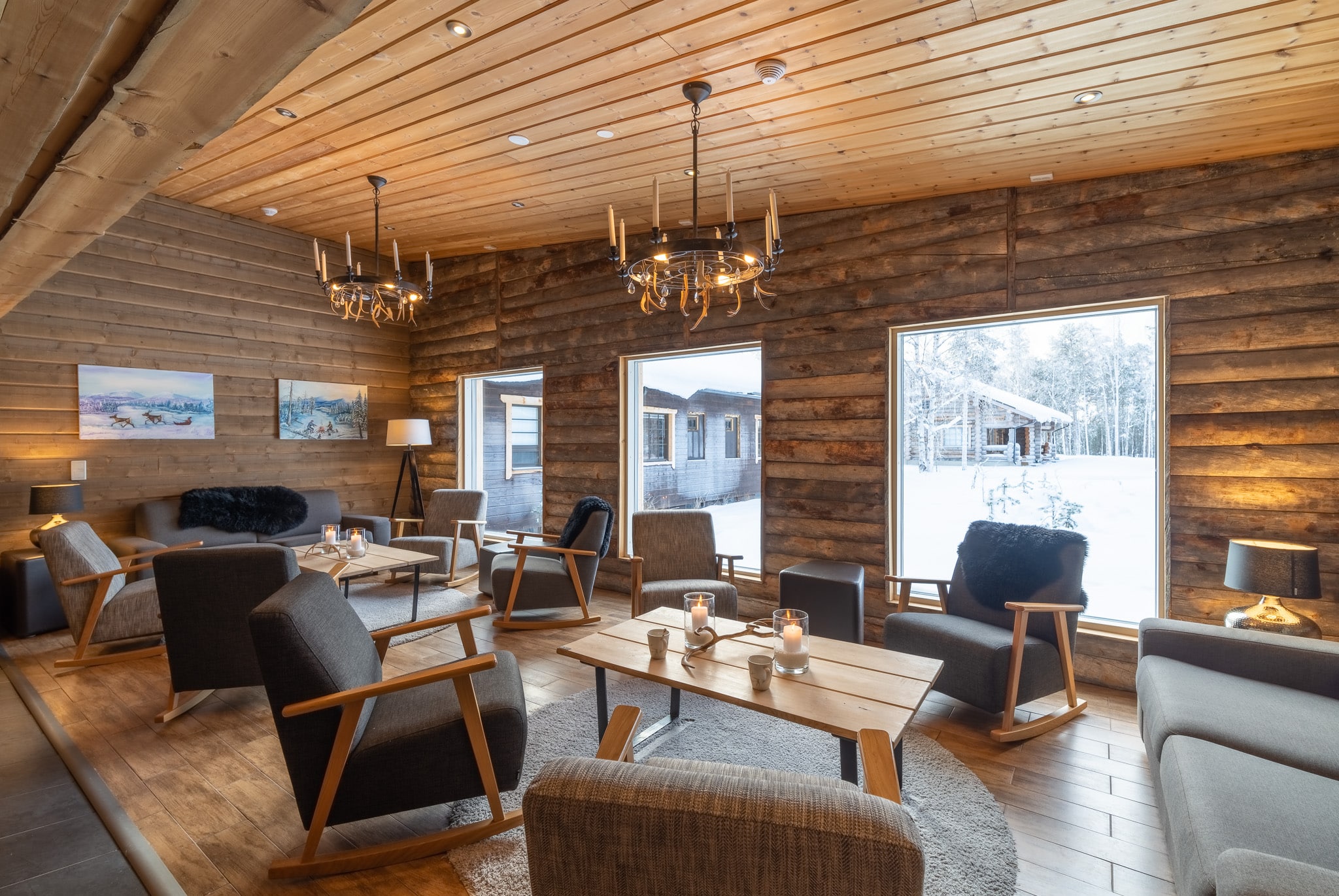 cosy lounge area with armchairs and 3 large windows