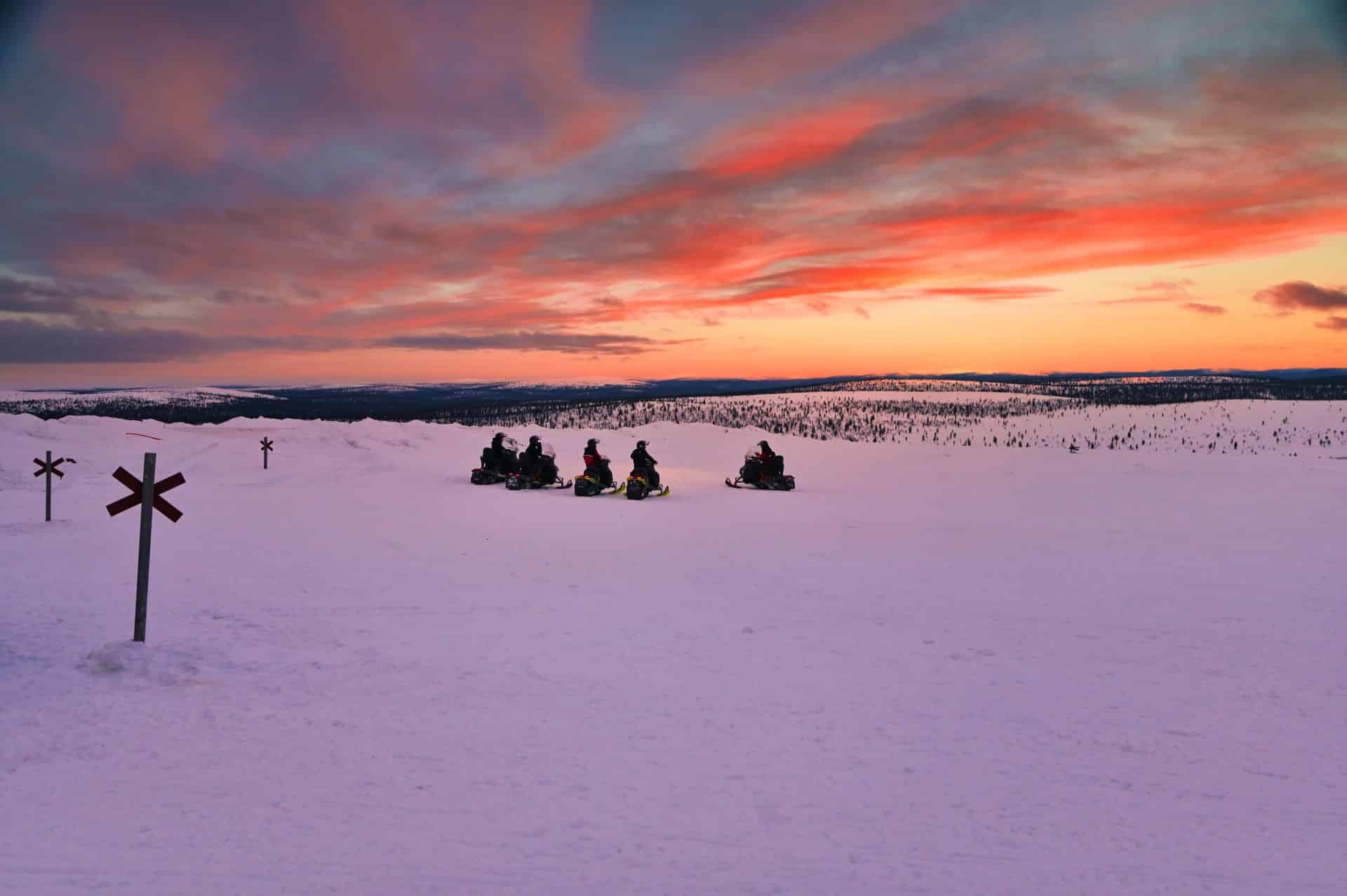 snowmobiling with sunset view