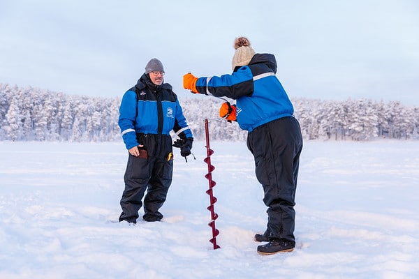 2 people doing ice fishing