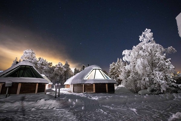glass igloos in the snow at night