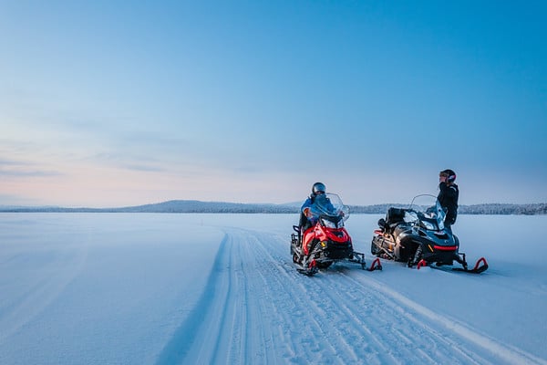 2 people snowmobiling