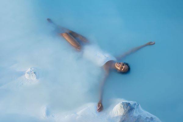 woman floating in blue lagoon