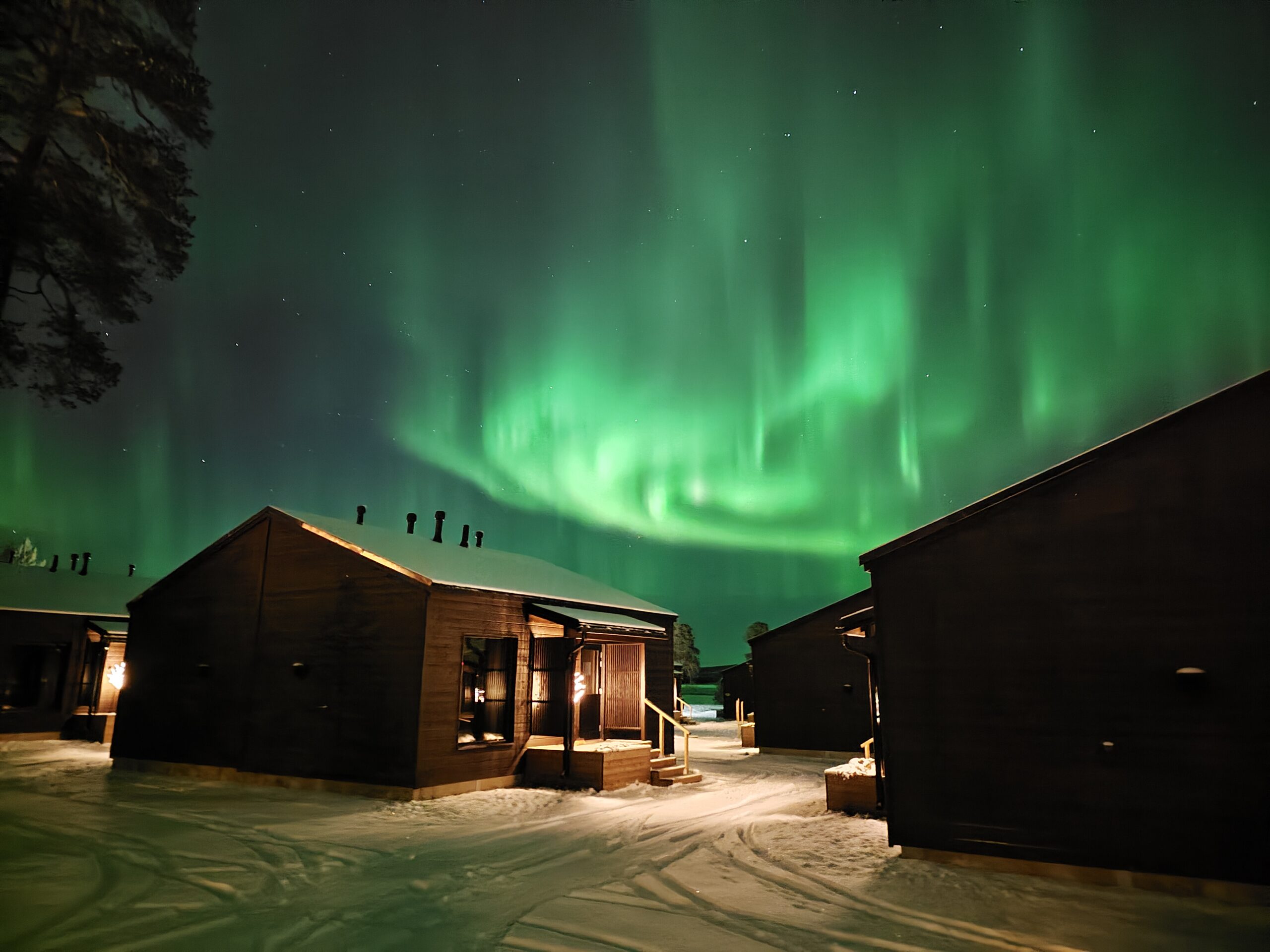 northern lights above cabins