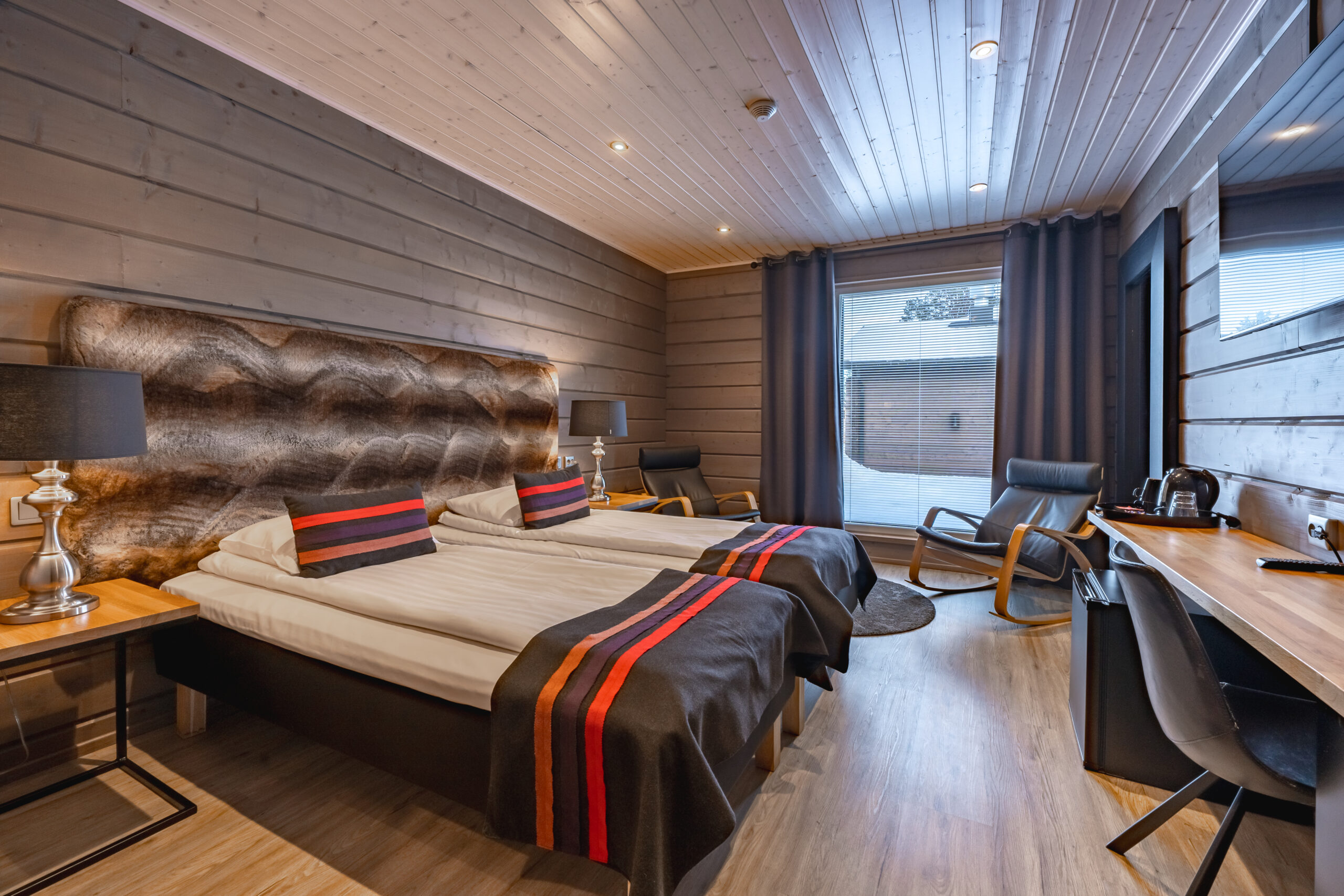 double bedroom with armchair and snowy view out the window