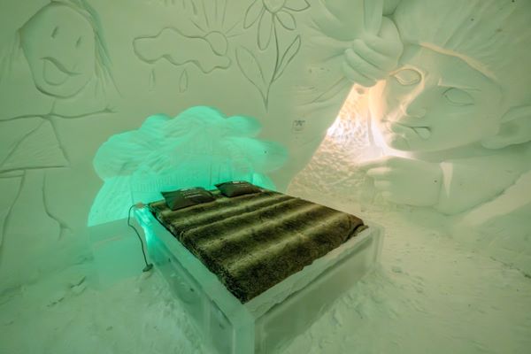 bed made from ice with snow carvings on the wall