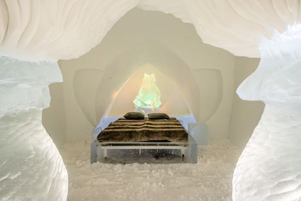 double bed made of ice in a snow room