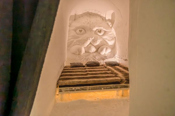 Ice hotel bedroom with ice beds decorated with snow sculptures