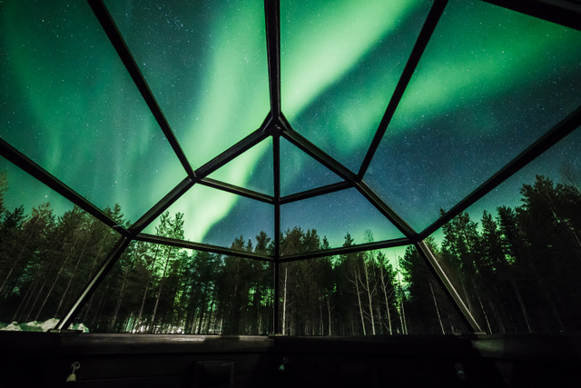 view of the northern lights from inside a glass igloo