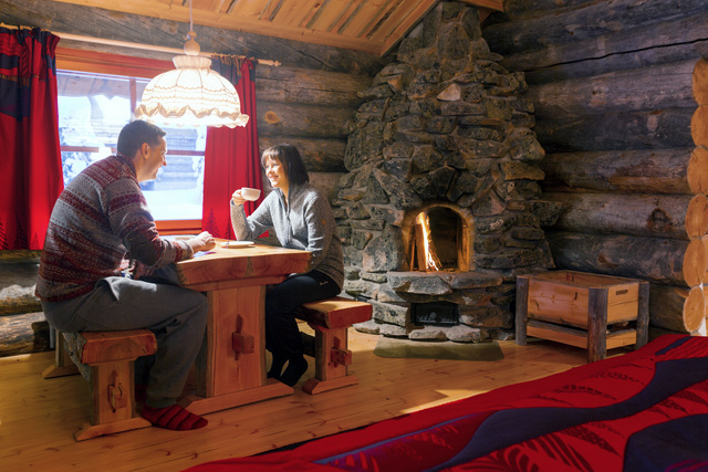 two people sat infront of the fireplace at the table