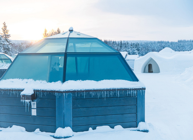 glass igloos covered in snow and ice