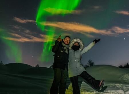 couple stood under the northern lights