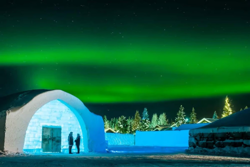 ice hotel entrance with northern lights above