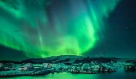 northern lights above the mountains