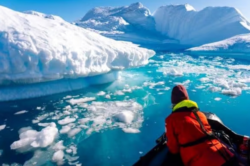 lady looking at antarctica icebergs