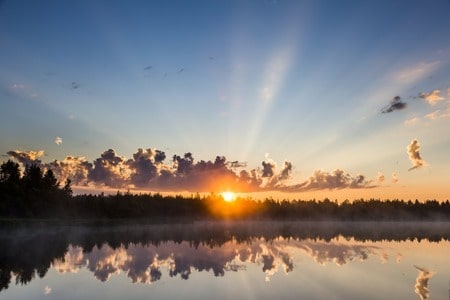 sun shining across the water