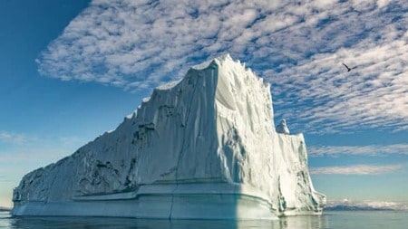 A large iceberg floating in the ocean