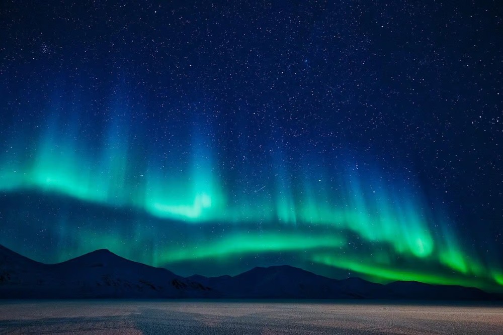 northern lights above mountains