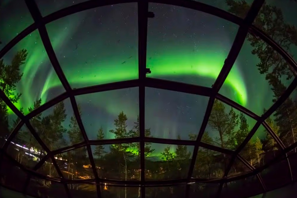 view of the northern lights from inside igloo