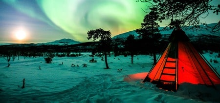 northern lights above snowy landscape