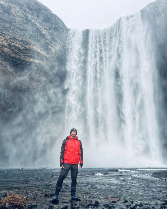 man by waterfall