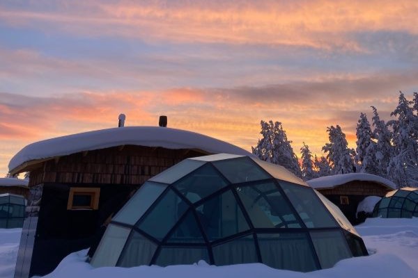 glass igloo in finland with sunset backdrop