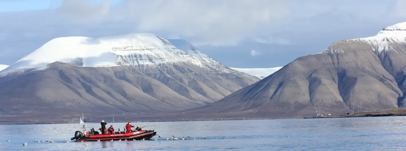 Boat trip with snow topped mountain in the background
