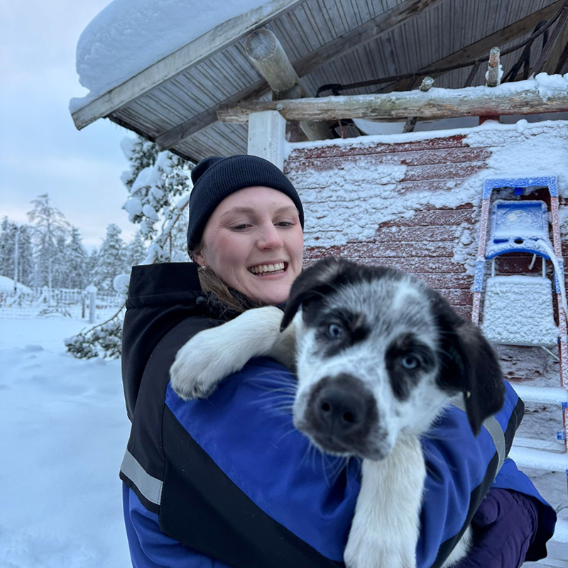 Holly from Arctic Direct holding a husky at Kakslauttanen
